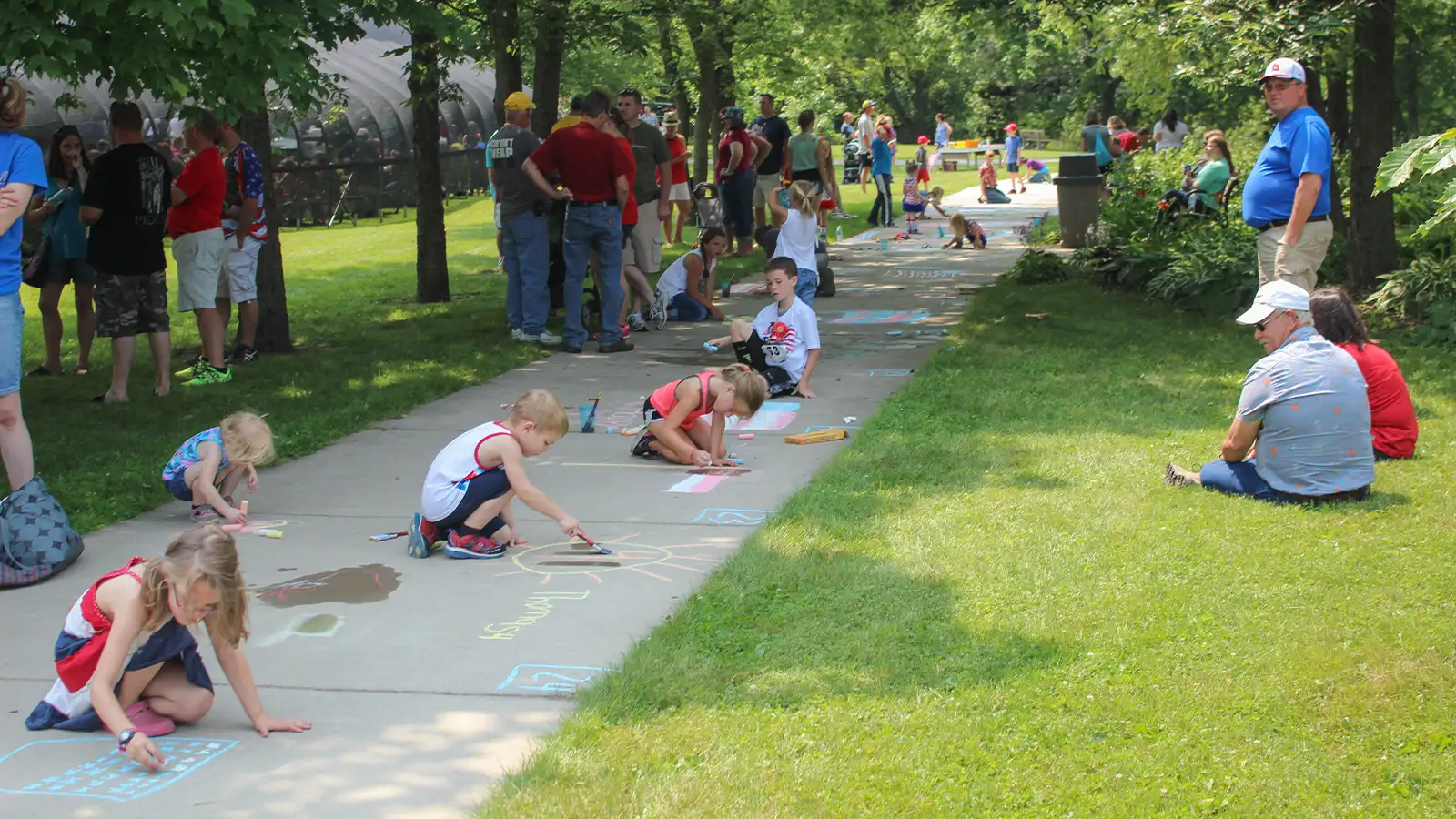 Kids playing with sidewalk chalk